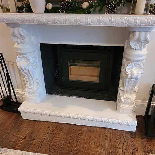 Stock photo of beautifully designed victorian style fireplace.  Tools are on the left.