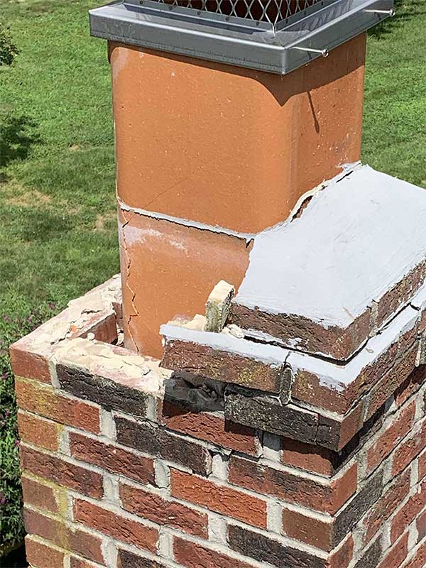 Stock photo of crumbling brick, crown and cracked flue.