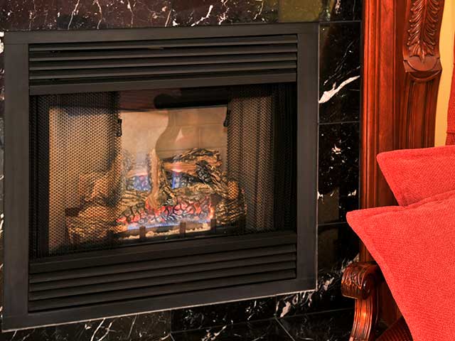 Stock photo of Gas fireplace Insert upgrade with marble surround.